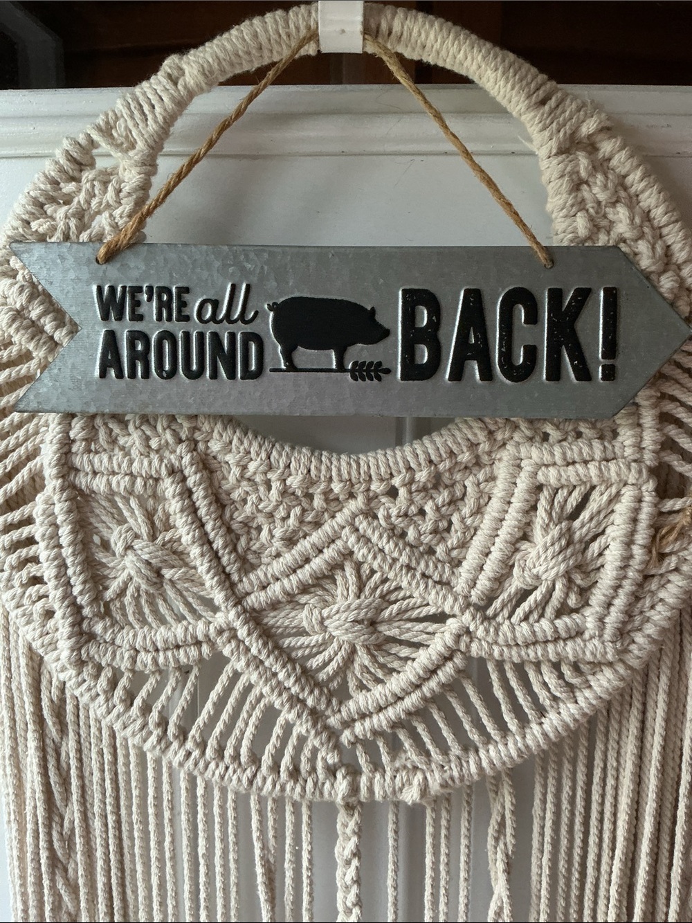 Rustic 'We're All Around Back!' Metal Wall Sign with Beige Macramé